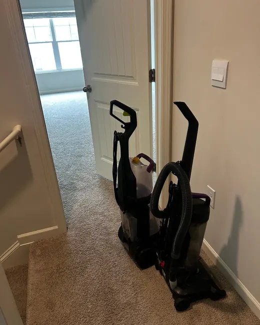 Two carpet cleaning machines set up in a hallway during a job
